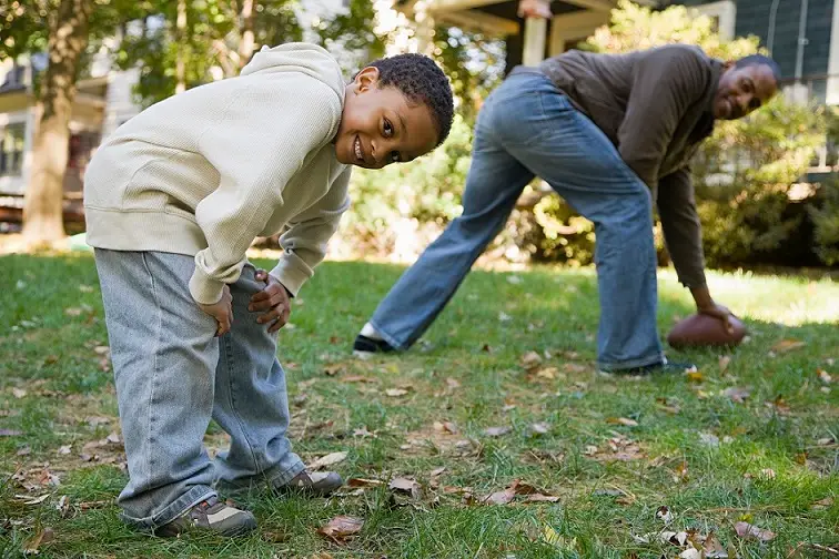 Father and son playing football - Your Savvy Purse