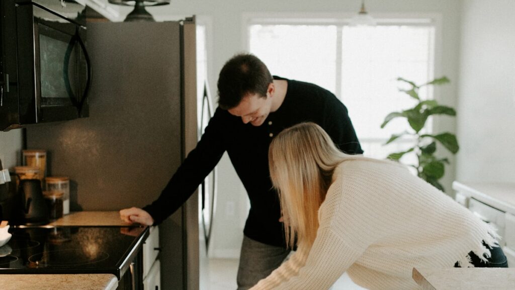 A parent and child in the kitchen during the morning family routine