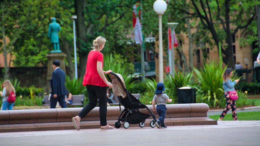 Mom pushing a stroller with her child in the park