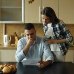 Couple reviewing bills together at their kitchen table