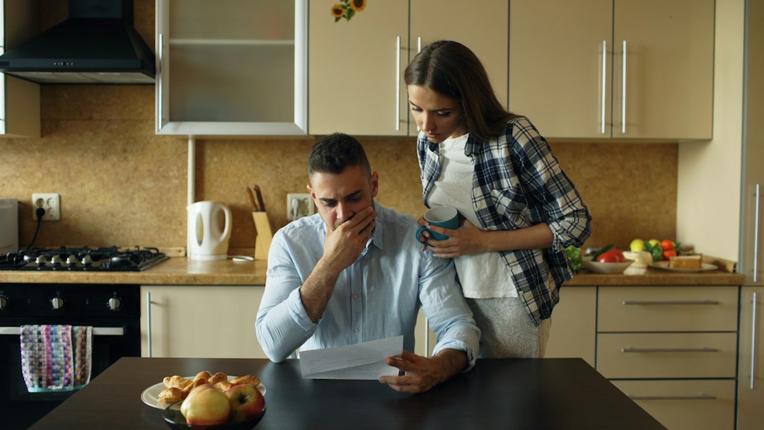Couple reviewing bills together at their kitchen table