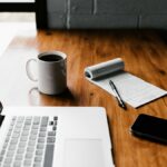 Laptop, coffee mug and smartphone on a desk