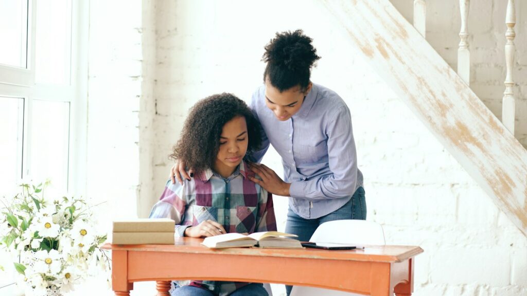 Mother helping daughter with homework at a desk