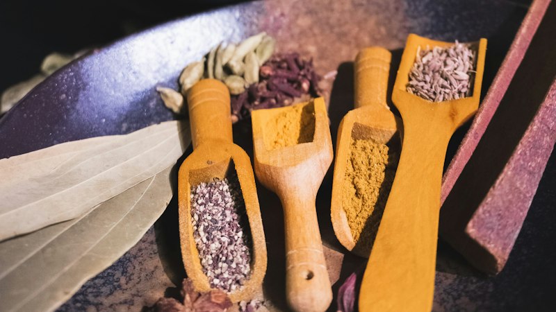 Spices, tomatoes, garlic and chickpeas arranged for cooking