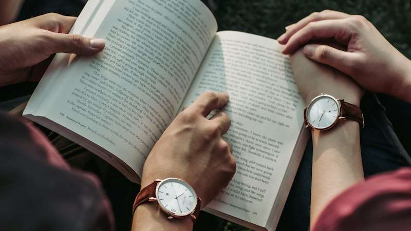 Two people reading books together